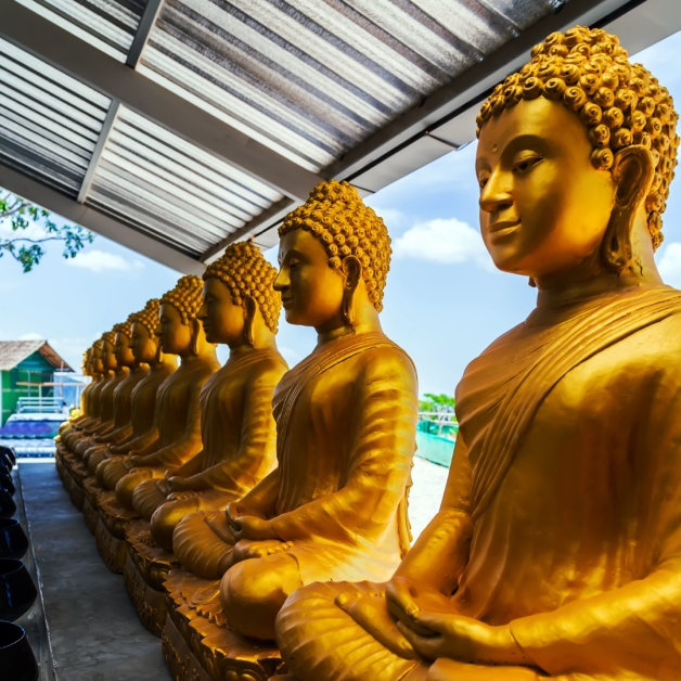 A line of golden buddha statues outside