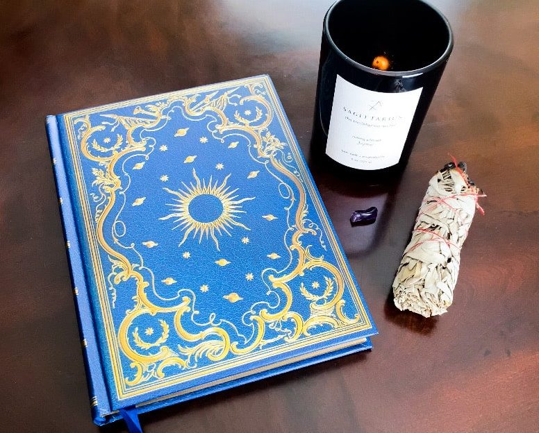 blue manifestation journal on a brown table