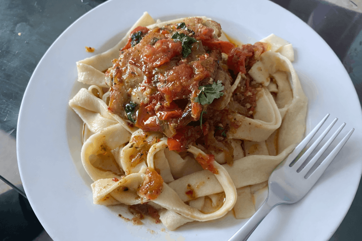 Italian pasta dish with dhicken on a white plate
