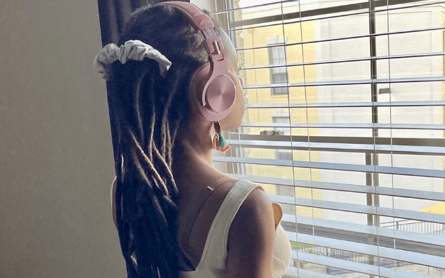 woman staring out of window pondering about something
