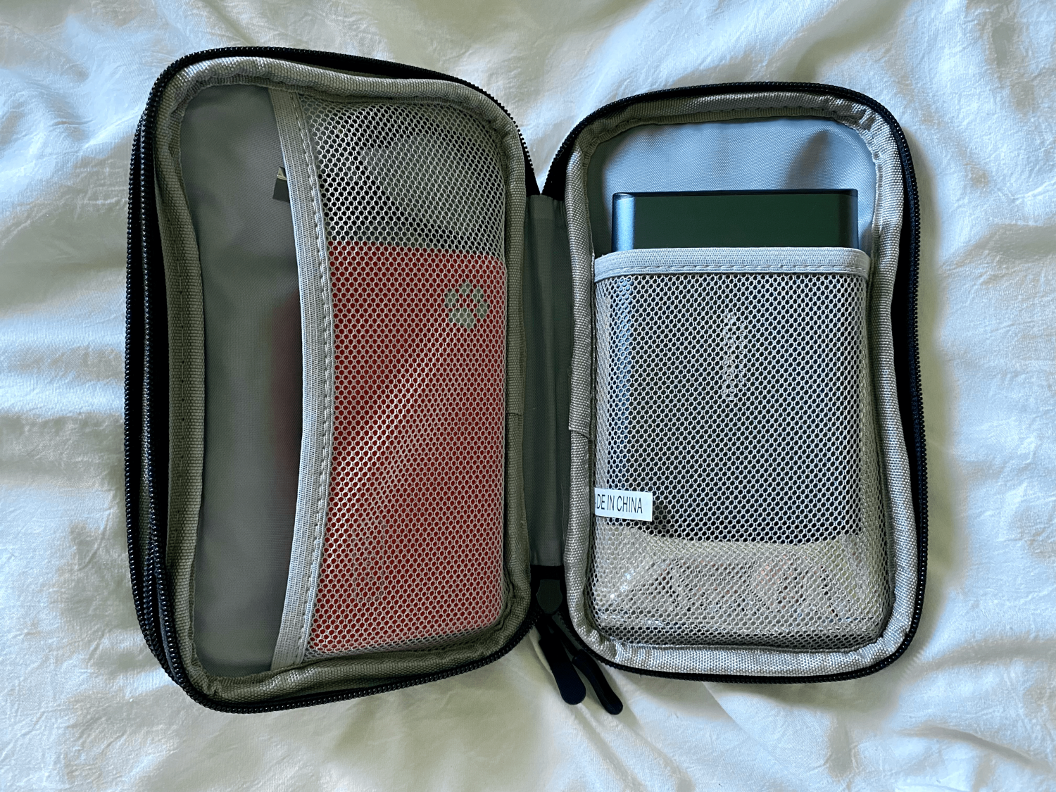 black tech organizer case with cables and chargers inside