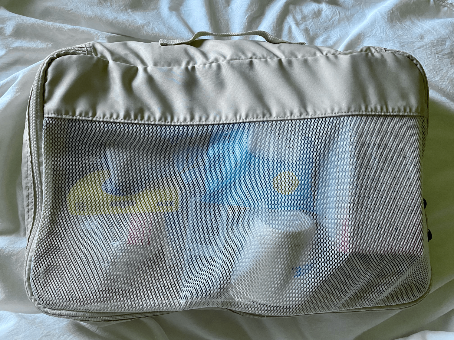 tan packing cube with items inside